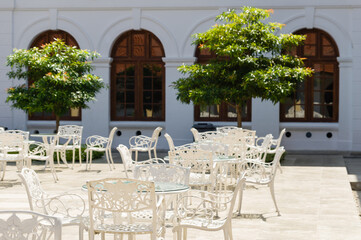 Clean and elegant outdoor cafe with white tables and chairs