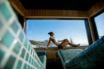 Young woman relaxing in the spa at winter season