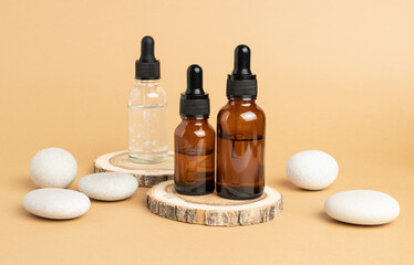 Wooden podium, stones and pipette bottles filled with oil or essence. Body care concept, natural...