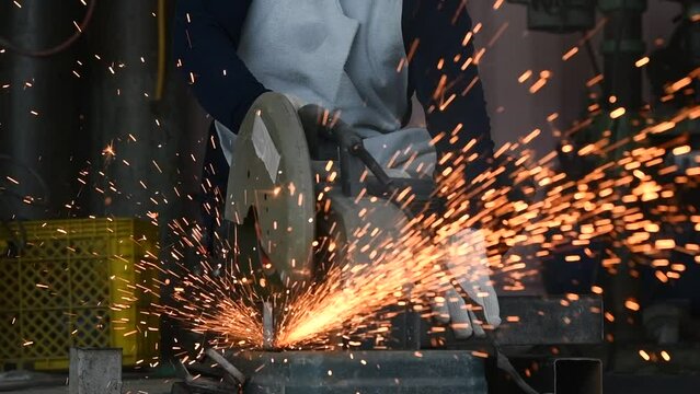 Close-up detail of construction engineer workers cutting rebar and rebar at a construction site Metal cutting workers sparks while grinding steel Cut the steel bar with a power tool.