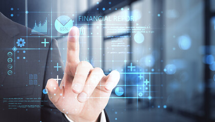 Close up of male hand pointing at abstract glowing blue financial report hologram on blurry bokeh office interior background with mock up place. 
