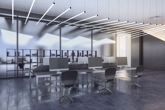 Modern industrial design project of open space office background with grey shades furniture, computers, glossy ceramic tales floor and row of LED lamps hanging from the ceiling. 3D rendering