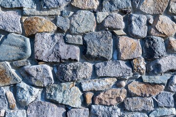 Background from a wall with stones in sunlight