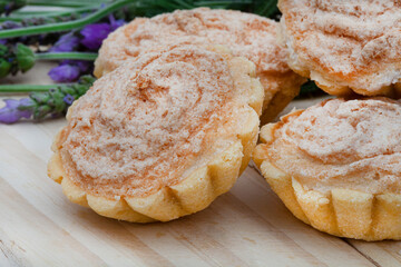 Traditional South African Hertzog koekies or tiny coconut tarts stuffed with apricot jam