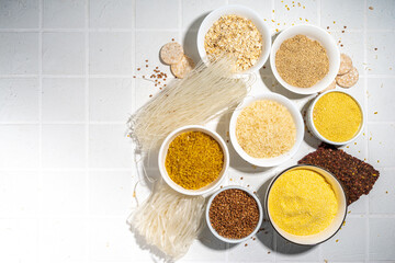 Selection of whole grains gluten free cereals. Set of various non-gluten cereals: rice, buckwheat, corn groats, quinoa, millet, oats, buckwheat, bulgur, porridge, barley, white background copy space