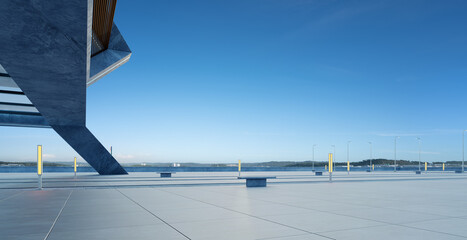 Perspective view of empty concrete floor and modern rooftop building