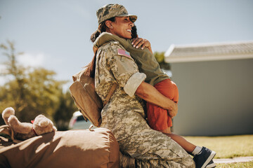 Joyful military mom reuniting with her son at home - obrazy, fototapety, plakaty