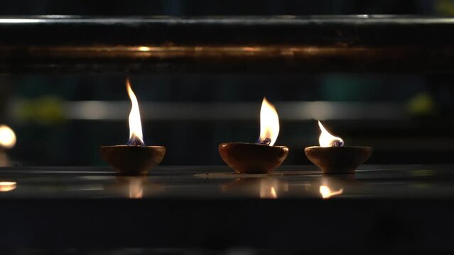 Burning diyas oil lamp inside a Hindu temple. Diwali festival or hindu prayers concept.