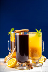 Collection of autumn winter hot drinks. Set of hot lemon ginger tea, mulled wine, fruit citrous...