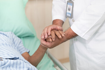 Doctor holding hands patient at hospital
