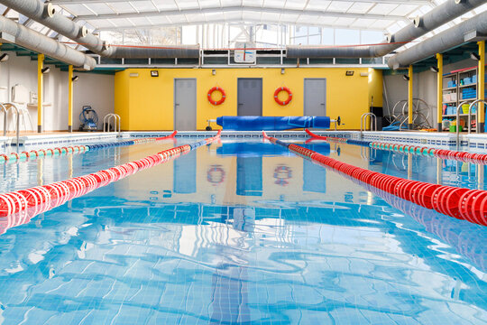 Empty pool with swimmer lanes in blue water