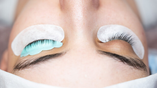 Close-up portrait of a woman in a beauty salon on eyelash lamination procedure. 
