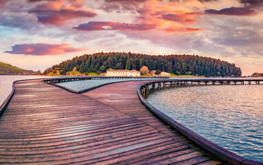 Naklejka na ściany i meble Great sunrise on St Mary's Monastery. Spectacular spring seascape of Narta Lagoon with old wooden pier. Beautiful outdoor scene of Albania, Europe. Traveling concept background.
