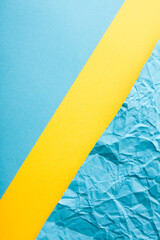 Minimal flat lay with flat and crumpled papers in yellow and blue color.