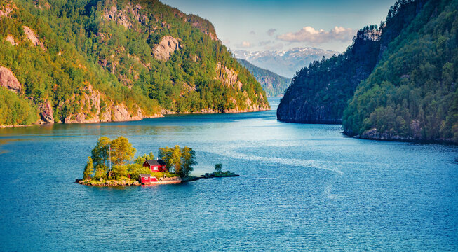 Superb summer view of Lovrafjorden flord with small island and typical Norwegian building, North sea. Splendid morning view in Norway. Beauty of nature concept background.