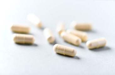 Selenium capsules. Concept for a healthy dietary supplementation. Bright paper background. Soft focus. Close up. Copy space.	