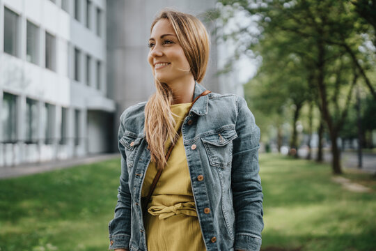 Happy Young Woman Standing In Park