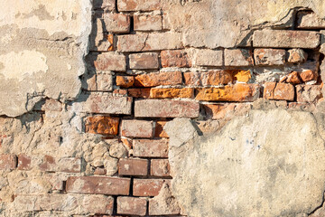 Old wall of broken bricks, background.