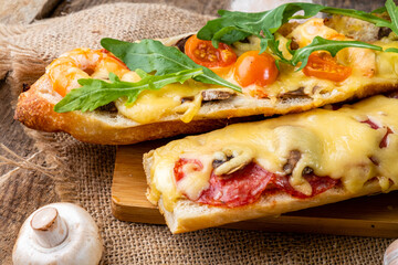 Pizza cooked on a baguette. Sandwich pizza with shrimps, cheese and sausages, close-up, selective focus. - obrazy, fototapety, plakaty