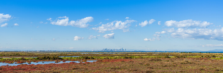 Panorama of undeveloped space with city skyline, in Point Cook, Melbourne, Australia.