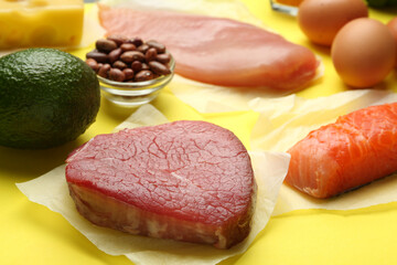 Set of products rich in amino acids on yellow background