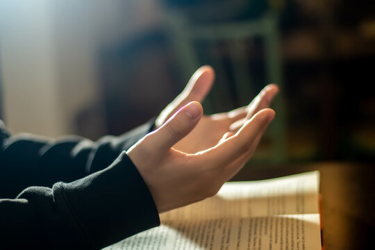 Religion concept, Young asian man reads bible and praying worship to god for faith and spirituality