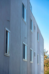 Dark gray building exterior with sliding glass window at San Francisco, California
