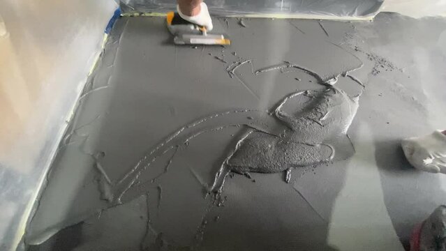 Applying a decorative microcement coating to the floor