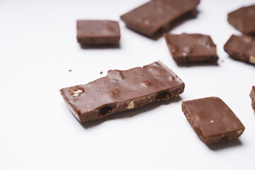 milk chocolate with hazelnuts and raisins is isolated on a white background. cooking concept