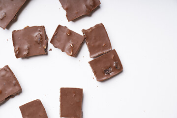 milk chocolate with hazelnuts and raisins is isolated on a white background. cooking concept