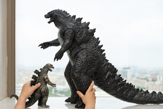 ZHONGSHAN GUANGDONG China-April 22,2022:kid playing two Godzillas and one is at normal size and the other is a giant one.