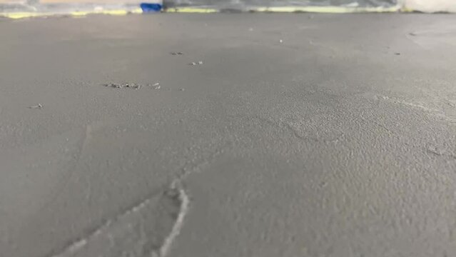 Applying a decorative microcement coating to the floor