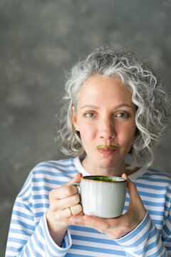 Woman With Matcha Tea Mustache Holding Cup