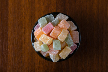 Traditional Turkish delight in a bowl on a wooden background	