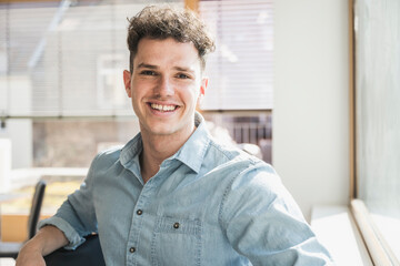 Portrait of smiling young businessman in office