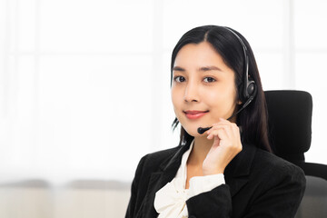Call centre female operator. Smiling asian business woman receptionist wearing headphone video...