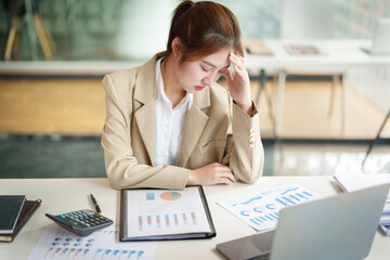 Burnout Syndrome. Portrait of Asian Business Woman feels uncomfortable working. Which is caused by stress, accumulated from unsuccessful work And less resting body. Consult a specialist psychiatrist.