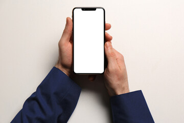 Man with smartphone on white background, top view