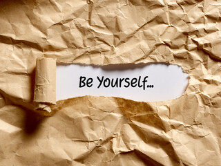 The motivational message be yourself written under a brown torn paper. - obrazy, fototapety, plakaty