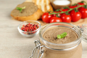 Glass jar with delicious liver pate on table, closeup. Space for text