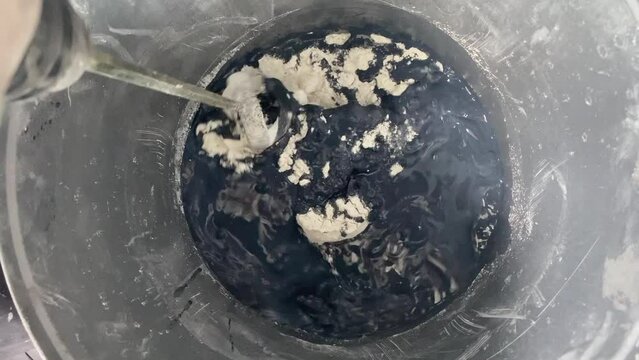 The process of combining the ingredients of the building mixture
