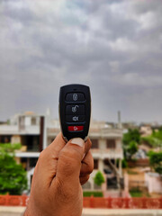 Picture of keys of a car shot on cloudy day depicting the weather is fun to go out for a drive