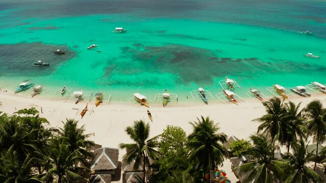 Tropical island with beautiful beach, palm trees and turquoise water view from above. Daco island, Philippines. Summer and travel vacation concept