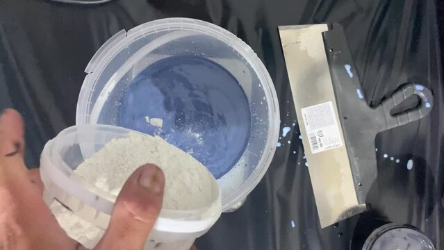 The process of combining the ingredients of the building mixture