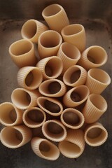 Italian dry pasta in the form of empty corrugated thick tubes