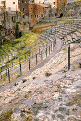 Interior of the Roman amphitheater of Catania with tourist taking photos