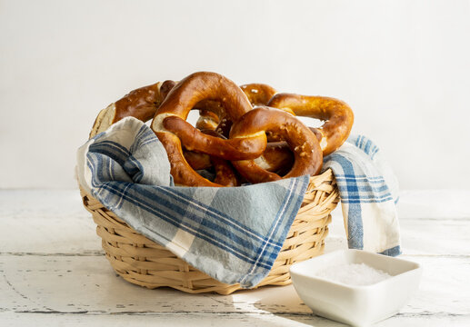 Brezels or pretzels in bread basket with napkin and salt