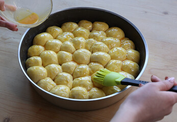 preparation of savory danube cake brushed with beaten egg