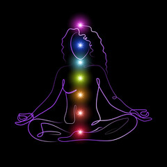 glowing chakras on linear silhouette of meditating woman - 500877533