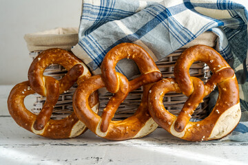 Group of brezels or pretzels in bread basket with napkin 